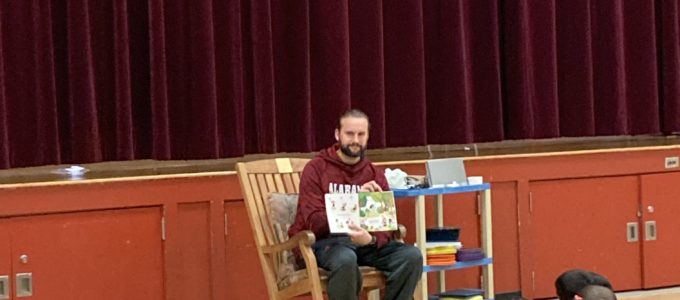 Mr. Bligh reading to students
